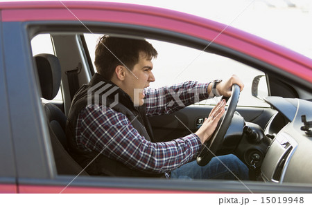 portrait of aggressive male driver honking in traffic jam portrait of aggressive male driver honking in traffic jam 15019948