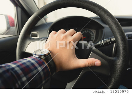 toned photo of male driver honking the horn 15019976
