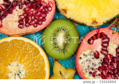 Colorful fruit slices on blue wood surface 15020884