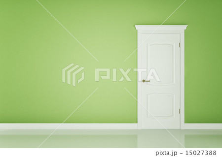 Closed white door on green wall 15027388