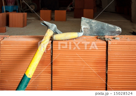 Hammer and trowel on construction site Hammer and trowel on construction site 15028524