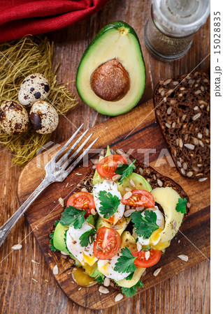 Bruschetta with tomato, avocado and quail egg Bruschetta with tomato, avocado and quail egg 15028835