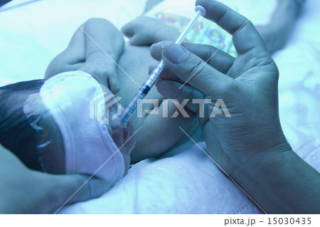 Doctor giving remedy to premature baby 15030435