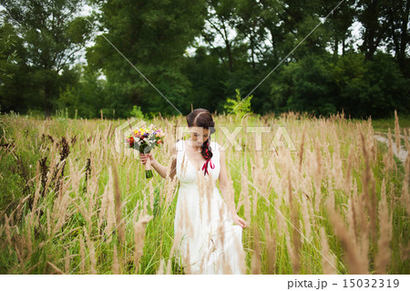 Young bride with bouquet of flowers in her hands Young bride with bouquet of flowers in her hands 15032319