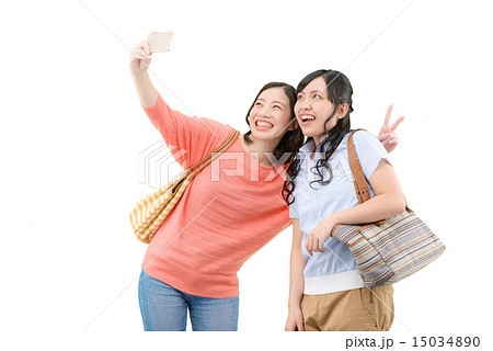 若い女性２人の仲良しポーズの白バックイメージの写真素材