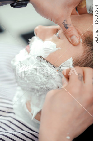Client shaving at barber shop 15038524