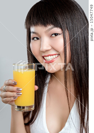 asian woman drinking orange juice 15047749