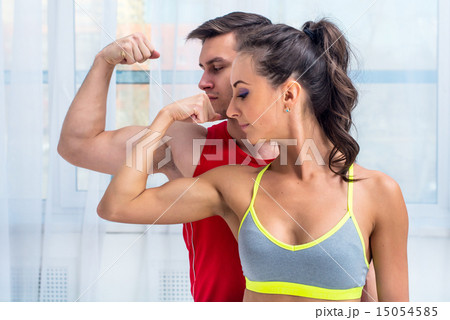 Active athletic sportive woman girl and man showing their muscles biceps healthy lifestyle 15054585