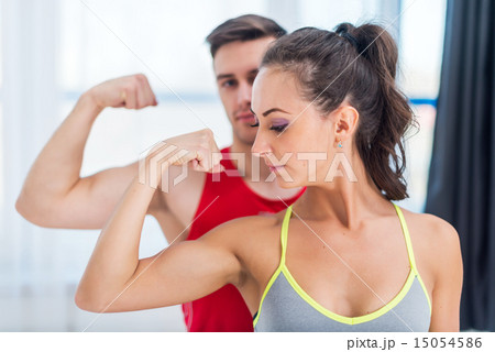 Active athletic sportive woman girl and man showing their muscles biceps healthy lifestyle 15054586