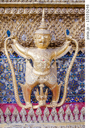 A Golden Garuda stands alone in front of a wall 15059246