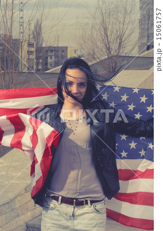 Younf black haired women with stars and stripes flag oytdoors 15061757