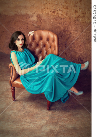 Woman sitting at leather armchair  15061825