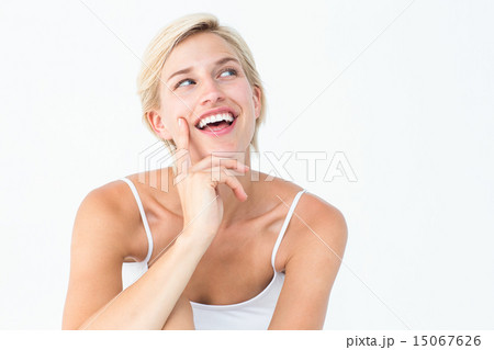 Pretty blonde woman smiling with finger on cheek Pretty blonde woman smiling with finger on cheek 15067626