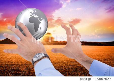 Composite image of businessman holding something with his hands 15067627