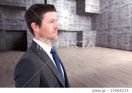 Composite image of handsome businessman looking away 15068235