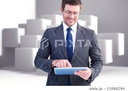 Composite image of businessman using his tablet pc 15068284