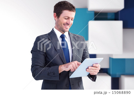Composite image of businessman using his tablet pc 15068890
