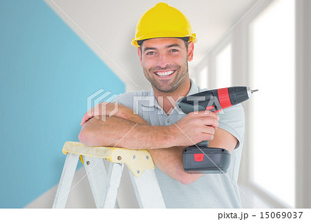 Composite image of male technician holding power drill on ladder 15069037