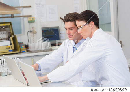 Scientists working attentively with laptop Scientists working attentively with laptop 15069390