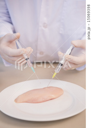 Scientist injecting piece of meat Scientist injecting piece of meat 15069398