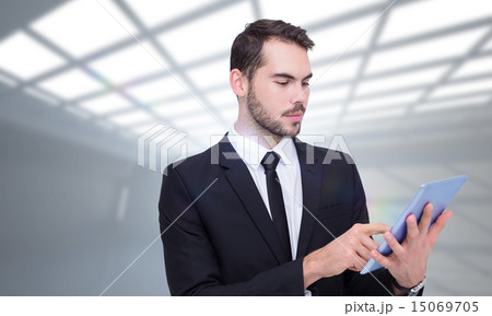 Composite image of cheerful businessman touching digital tablet 15069705