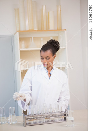 Concentrated scientist working attentively with pipette 15069790
