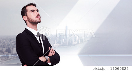 Composite image of thinking businessman with his arms crossed Composite image of thinking businessman with his arms crossed 15069822