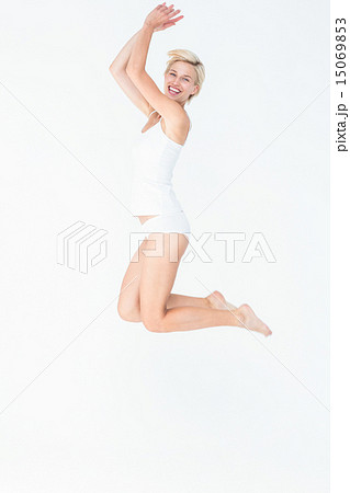 Cheerful blonde woman jumping 15069853