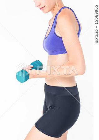 Pretty woman in sportswear lifting dumbbell 15069965