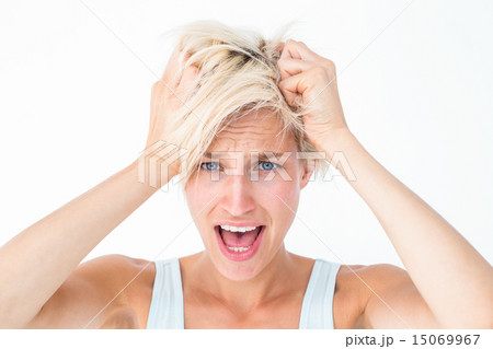 Stressed woman screaming and holding her head 15069967