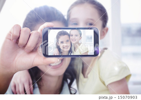 Composite image of hand holding smartphone showing Composite image of hand holding smartphone showing 15070903