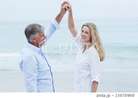 Happy couple dancing by the sea Happy couple dancing by the sea 15070960