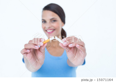 Happy woman breaking a cigarette 15071164