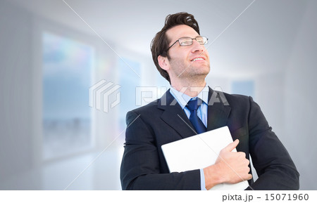 Composite image of handsome businessman holding his laptop Composite image of handsome businessman holding his laptop 15071960