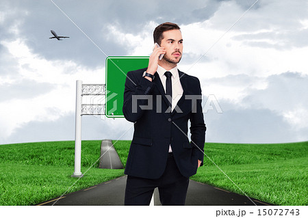 Composite image of serious businessman hand in pocket phoning 15072743