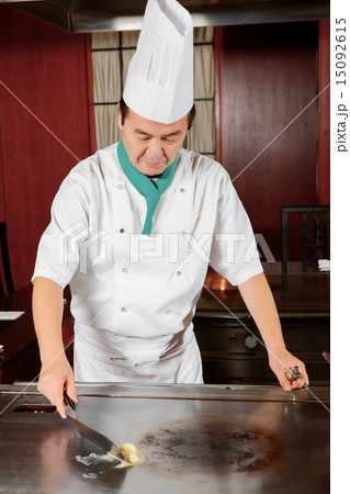 Cook puts vegetables to the dish Cook puts vegetables to the dish 15092615