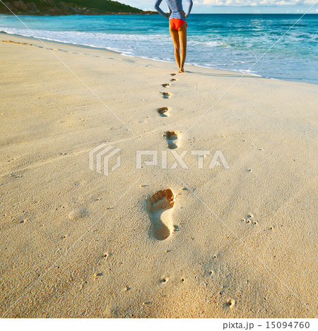 Woman at beautiful beach. Focus on footprints. Woman at beautiful beach. Focus on footprints. 15094760