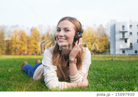 Student listening and touching earphone by hand Student listening and touching earphone by hand 15097930