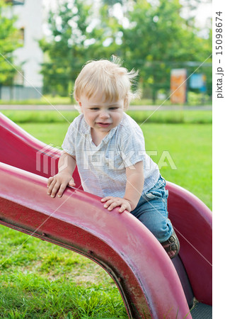 Baby kid standing on red slide Baby kid standing on red slide 15098674