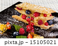 millefeuille with berries on a dark caramel plate 15105021