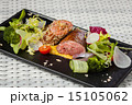 Veal sauce with vegetables on dark plate 15105062