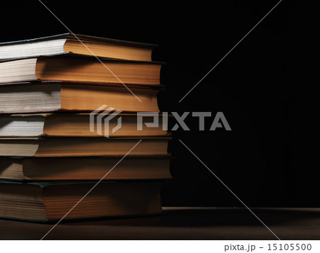 Pile of hardcover books in a shadowy room Pile of hardcover books in a shadowy room 15105500