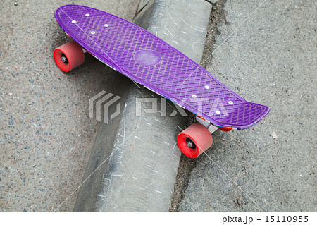 Skateboard stands on the curb of asphalt road Skateboard stands on the curb of asphalt road 15110955