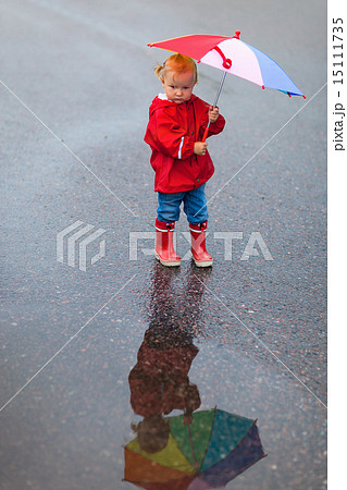 Toddler girl with colorful umbrella on rainy day Toddler girl with colorful umbrella on rainy day 15111735