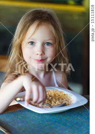 Little girl eating breakfast 15111816