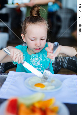 Little girl eating breakfast Little girl eating breakfast 15112163