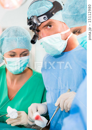 Surgeons operating in operation theater room Surgeons operating in operation theater room 15112980