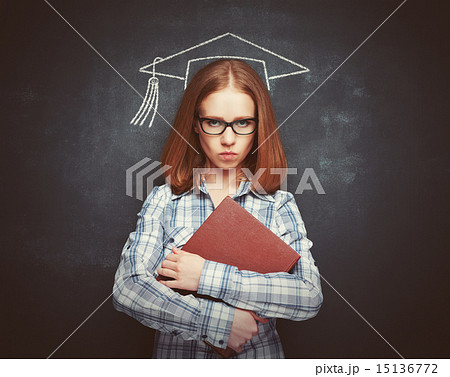 student girl in cap, glasses and a book at  blackboard student girl in cap, glasses and a book at  blackboard 15136772