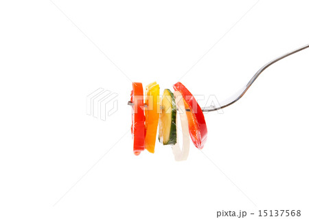 Slices of fresh vegetables in oil on a fork. Slices of fresh vegetables in oil on a fork. 15137568