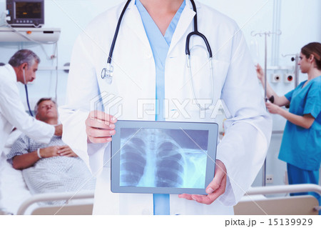 Composite image of doctor looking at xray on tablet Composite image of doctor looking at xray on tablet 15139929